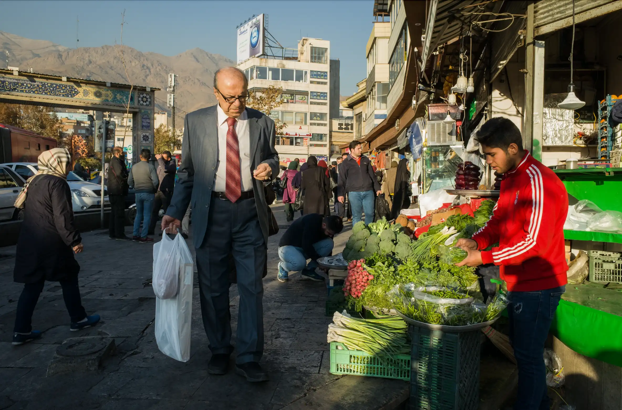 A man with a shopping bag in Tajrish