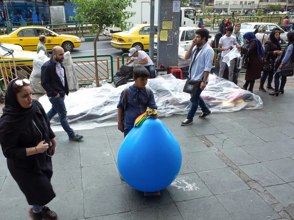 A boy selling ballon in the street